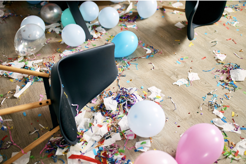 chairs and balloons on the floor after a party